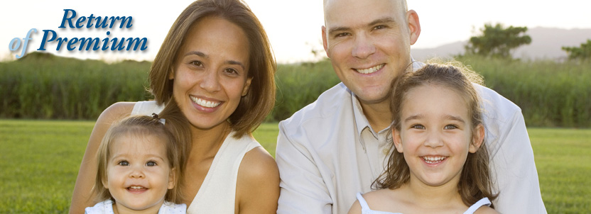 Smiling family sitting in grass